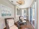 Cozy sunroom with wicker chairs, wood floors, and large sliding glass doors at 7728 Club Ln, Sarasota, FL 34238