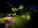 Backyard with walkway, landscaping, and accent lighting in a peaceful setting at 8133 Grande Shores Dr, Sarasota, FL 34240