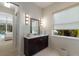 Stylish bathroom featuring a dark vanity, decorative lights, and a serene atmosphere at 8133 Grande Shores Dr, Sarasota, FL 34240