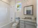 Bright bathroom with tub and shower, modern vanity, and stylish fixtures for a clean look at 8133 Grande Shores Dr, Sarasota, FL 34240