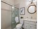 A bathroom with a glass enclosed shower, and modern round rope mirror at 8133 Grande Shores Dr, Sarasota, FL 34240