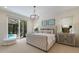 Luxurious bedroom featuring a king-size bed, natural light, and a view of the pool area at 8133 Grande Shores Dr, Sarasota, FL 34240