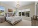 A bright bedroom features many windows, neutral colors, and a ceiling fan at 8133 Grande Shores Dr, Sarasota, FL 34240