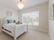 Cozy bedroom featuring a white bed frame, a tray on the bed, and soft natural light at 8133 Grande Shores Dr, Sarasota, FL 34240