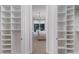 A closet featuring custom shelving on either side of a doorway leading to the main bedroom and the pool at 8133 Grande Shores Dr, Sarasota, FL 34240