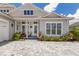 Close-up of a home's exterior with well-manicured landscaping and a welcoming front porch at 8133 Grande Shores Dr, Sarasota, FL 34240