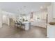 Spacious kitchen featuring modern stainless steel appliances, white cabinets, and an eat-in island at 8133 Grande Shores Dr, Sarasota, FL 34240