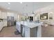 Bright kitchen featuring white cabinets, a large island, stainless steel appliances, and an open layout at 8133 Grande Shores Dr, Sarasota, FL 34240