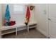 Well-organized mudroom with bench seating, storage shelves, and natural light from a window at 8133 Grande Shores Dr, Sarasota, FL 34240