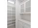 Well-organized pantry with white shelving and cabinets, maximizing storage space in this modern home at 8133 Grande Shores Dr, Sarasota, FL 34240