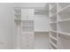 Custom walk-in closet offering ample storage with adjustable shelves, drawers, and hanging rods at 8133 Grande Shores Dr, Sarasota, FL 34240
