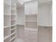 Custom walk-in closet offering ample storage with adjustable shelves, drawers, and hanging rods at 8133 Grande Shores Dr, Sarasota, FL 34240