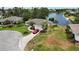 Tranquil home next to a large pond, featuring a nicely kept lawn and a paved driveway at 8808 44Th Avenue W Dr, Bradenton, FL 34210