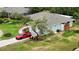 Aerial view of home with beautiful landscaping, new driveway, a red sports car, and a well-manicured lawn at 8808 44Th Avenue W Dr, Bradenton, FL 34210