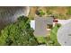 Aerial view of house with well maintained backyard, beautiful trees and a nice, long driveway at 8808 44Th Avenue W Dr, Bradenton, FL 34210