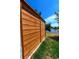 Exterior view of backyard wooden fence, lawn and waterfront canal on a bright sunny day at 8808 44Th Avenue W Dr, Bradenton, FL 34210
