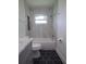 Well-lit bathroom with a tub-shower combo, marble-look vanity, and patterned tile floor at 8808 44Th Avenue W Dr, Bradenton, FL 34210