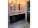 Bright bathroom with double sink vanity, decorative mirrors, and stylish tile flooring at 8808 44Th Avenue W Dr, Bradenton, FL 34210