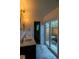 Bright bathroom featuring dual sinks, stylish lighting, and access to a private outdoor patio at 8808 44Th Avenue W Dr, Bradenton, FL 34210