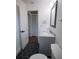 Bathroom boasts hexagon tile floor, gray vanity with marble countertop and decorative mirror at 8808 44Th Avenue W Dr, Bradenton, FL 34210
