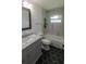Modern bathroom features gray vanity with marble top, hexagon tile flooring, and shower/tub combo at 8808 44Th Avenue W Dr, Bradenton, FL 34210