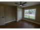 Neutral bedroom with wood floors, ceiling fan, closet and a window with blinds at 8808 44Th Avenue W Dr, Bradenton, FL 34210
