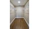 Walk-in closet with wood flooring and custom shelving for optimal organization at 8808 44Th Avenue W Dr, Bradenton, FL 34210
