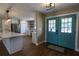 Open-concept entryway featuring a modern front door, a view of the kitchen, and hardwood flooring at 8808 44Th Avenue W Dr, Bradenton, FL 34210