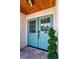 Elegant double front doors in light blue with a decorative transom and stone tile entryway at 8808 44Th Avenue W Dr, Bradenton, FL 34210