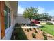 Beautifully landscaped home with a blue front door, wooden shutters, and a brick walkway at 8808 44Th Avenue W Dr, Bradenton, FL 34210