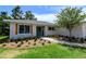 Charming home entrance featuring a brick walkway, blue door, and decorative wooden shutters at 8808 44Th Avenue W Dr, Bradenton, FL 34210