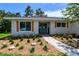 Inviting entrance with a blue front door, stylish shutters, and neatly landscaped garden at 8808 44Th Avenue W Dr, Bradenton, FL 34210