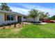 Beautiful home's lawn with lush landscaping and a tree providing shade near the driveway and front walkway at 8808 44Th Avenue W Dr, Bradenton, FL 34210