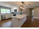 Renovated kitchen with island, stainless steel appliances, unique backsplash, and wood-look flooring at 8808 44Th Avenue W Dr, Bradenton, FL 34210