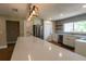 Spacious kitchen with quartz counters, stainless steel appliances, large island and wood grain flooring at 8808 44Th Avenue W Dr, Bradenton, FL 34210