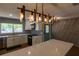 Stylish kitchen featuring an island, modern lighting, and contrasting backsplash, a culinary dream at 8808 44Th Avenue W Dr, Bradenton, FL 34210