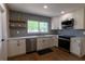 Updated kitchen with new appliances, white cabinets, patterned tile backsplash, and open shelving at 8808 44Th Avenue W Dr, Bradenton, FL 34210