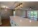 Open concept kitchen featuring a large island, modern lighting, and seamless flow to the living area at 8808 44Th Avenue W Dr, Bradenton, FL 34210
