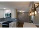 Bright kitchen with white cabinets, quartz countertops, and a unique backsplash, open to the entryway at 8808 44Th Avenue W Dr, Bradenton, FL 34210