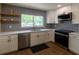 Bright kitchen with stainless steel appliances, quartz countertops, and a patterned tile backsplash at 8808 44Th Avenue W Dr, Bradenton, FL 34210