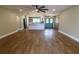 Wide view of open floorplan showing kitchen, dining, and living areas and bright blue entry door at 8808 44Th Avenue W Dr, Bradenton, FL 34210