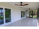Enclosed lanai with access doors and ceiling fans at 8808 44Th Avenue W Dr, Bradenton, FL 34210