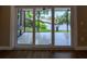 This is an outdoor patio with sliding glass doors and a view of a lake at 8808 44Th Avenue W Dr, Bradenton, FL 34210