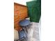 Intimate patio space with black metal bistro set and stylish wood and greenery backdrop at 8808 44Th Avenue W Dr, Bradenton, FL 34210
