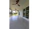 Enclosed lanai showing ceiling fans, tile flooring, and access to outdoor space at 8808 44Th Avenue W Dr, Bradenton, FL 34210