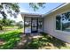 View of the screened-in porch with outdoor fan and tile flooring, sliding glass doors, and backyard pond view at 8808 44Th Avenue W Dr, Bradenton, FL 34210