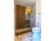 Modern shower featuring stylish wood wall accents, glass door and hexagon-shaped tile flooring at 8808 44Th Avenue W Dr, Bradenton, FL 34210