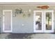 Enclosed back porch with a view to the backyard, decorated with nautical decor at 10827 Village Green Ave, Seminole, FL 33772