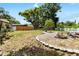Well-kept backyard with a gravel area, patio stones, and mature trees at 10827 Village Green Ave, Seminole, FL 33772