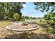Nice backyard with a small palm tree, rocks and a white picket fence at 10827 Village Green Ave, Seminole, FL 33772